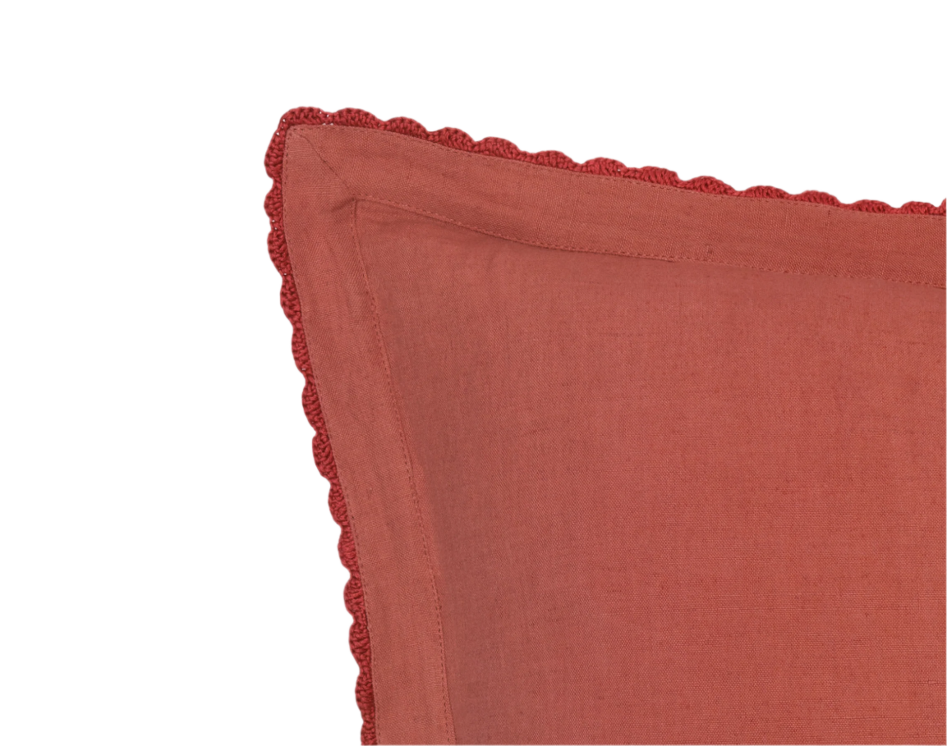 close up of the persimmon pillow with hand crocheted trim