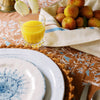 holly vine terracotta tablecloth styled with a fruit basket and glass of orange juice