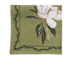 close up of magnolia flower on a green napkin