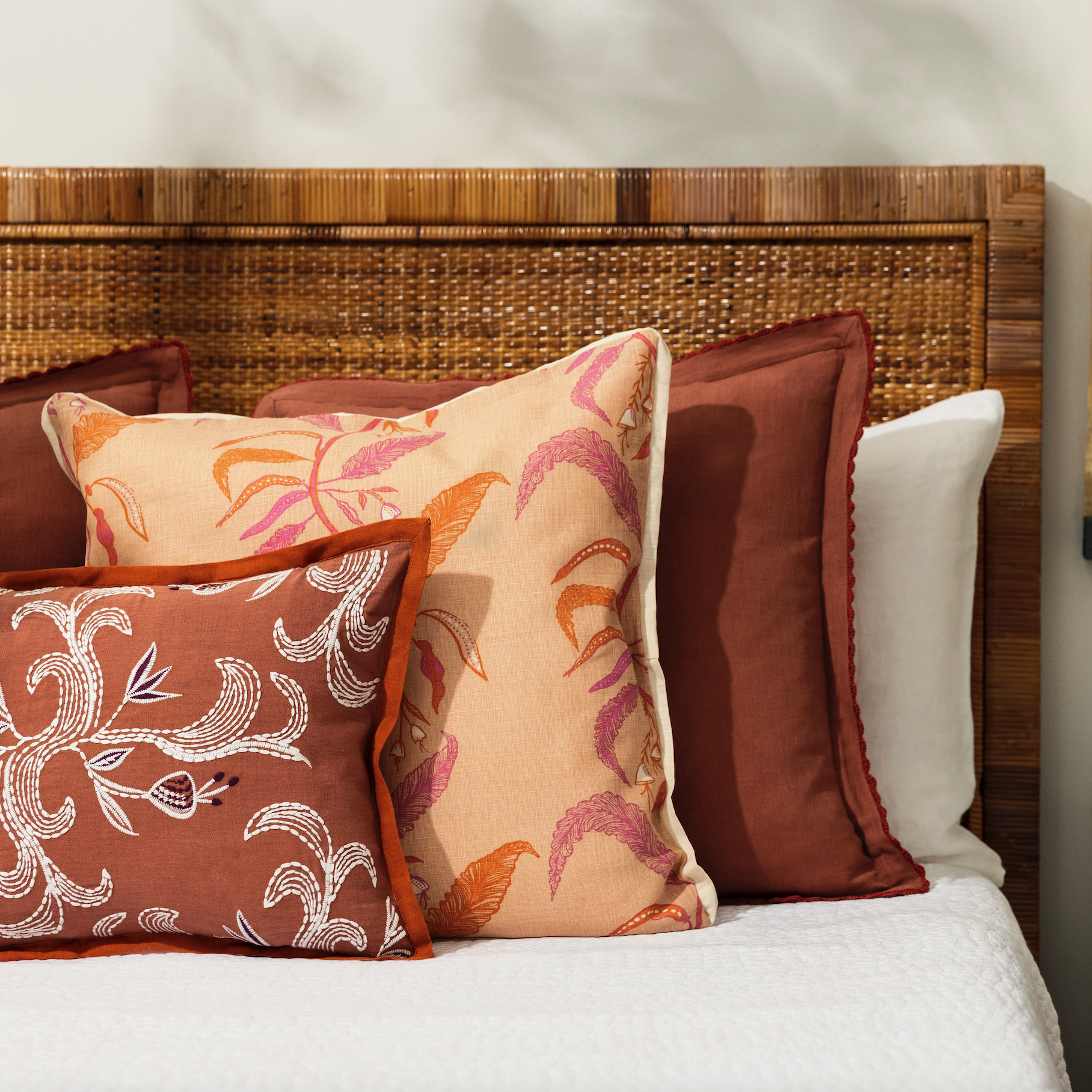 pillows on a bed with white bed linen