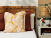 tuileries citrine pillow on a bed with white bed linen and night stand with bud vases