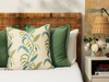 tuileries garden pillow with floral pattern with green pillows and a night stand with a small bouquet of flowers