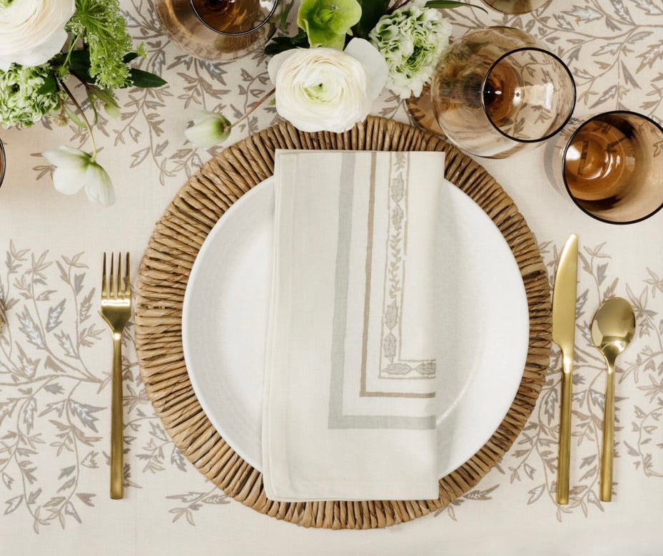 place setting with a natural napkin on a plate