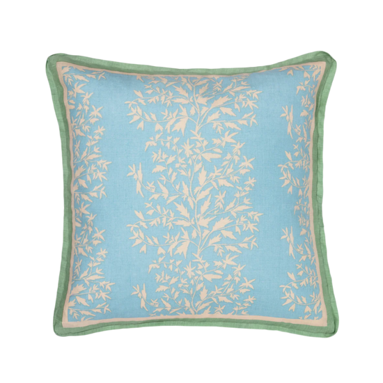 primrose azul pillow with contrasting green trim photographed against a white background