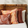 pillows on a bed with white bed linen