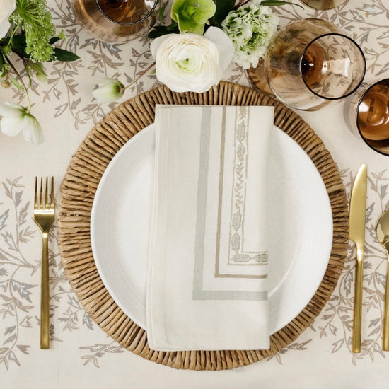 place setting with a natural napkin on a plate